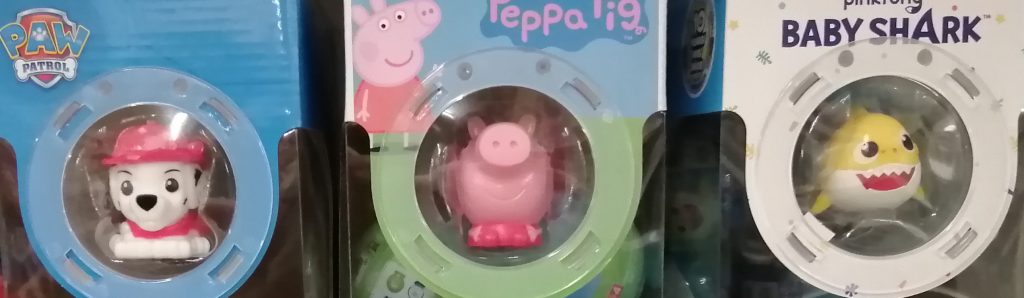 Peppa Pig, Baby Shark, Paw Patrol toys: stylised 'cute' versions, packaged on supermarket shelf