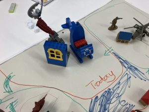 detail of a prototype board game made of paper, toys and LEGO