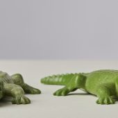 Two Playmobil toy crocodiles in green plastic. Their jointed mouths are open.