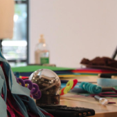 a cluttered desk from this research workshop, with coloured felt, pens and a Sphero robot